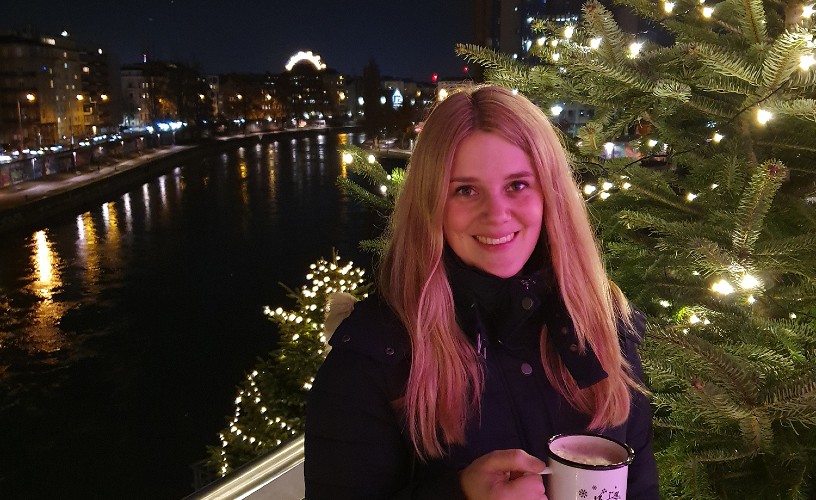 Sabrina Shutter from Bristol BID with a hot chocolate by a Christmas tree